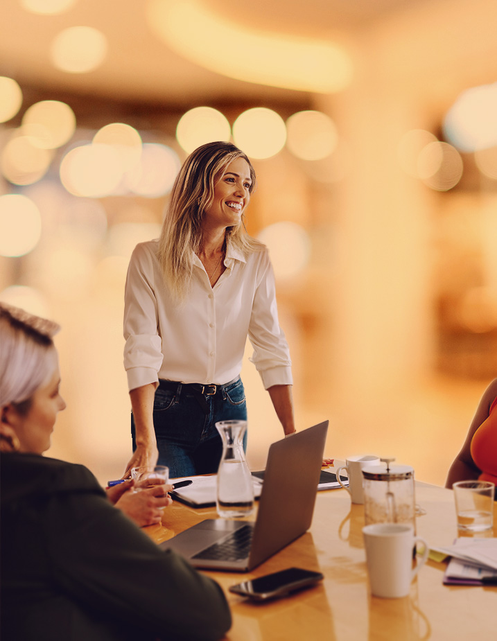 Business woman presenting to group, bokeh background